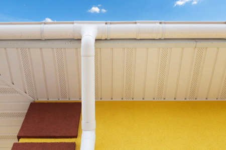 New rain gutter on yellow wall
