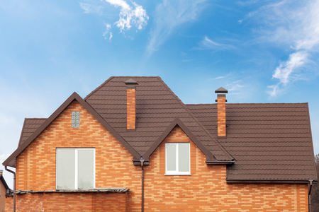 New brick house with modular chimney, Stone Coated Metal Roof Tile, plastic windows and rain gutterの写真素材