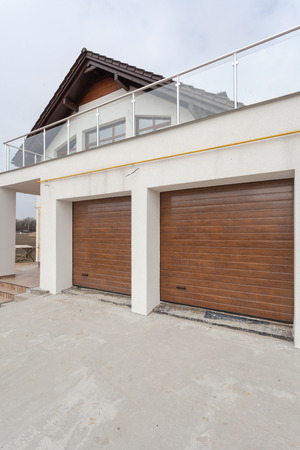 Garage doors in new white house made of blocksの写真素材