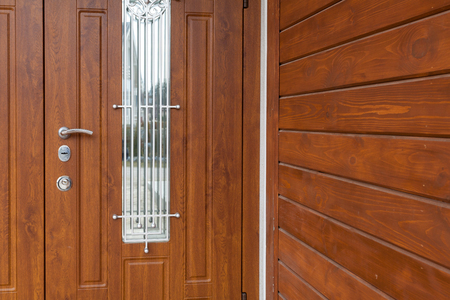 Modern style metallic door handle on wooden doorの写真素材