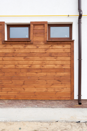 Plastic PVC Window and rain gutter in New Modern Passive Wooden House Facade Wallの写真素材