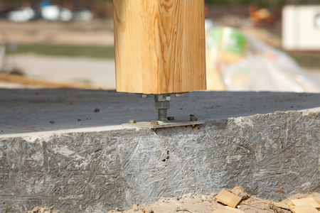 Wooden pillar on the construction site concrete with screw. Wooden Pillars are structures that can be placed on Foundations or Platforms.の写真素材