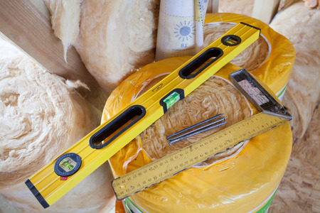 Construction level with square triangle on fiberglass insulation materialの写真素材