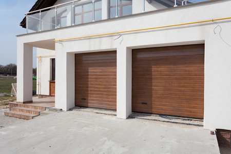 New white house with double garage doors and balconyの写真素材