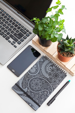 White office desk table with a lot of things on it. Top view with copy space, flat lay.の写真素材