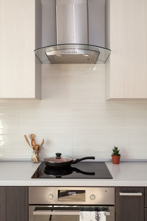 Closeup of exhaust hood and ceramic cooking plate in the new modern kitchenの写真素材