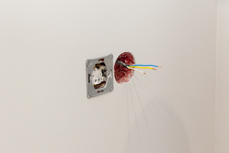 Installing the sockets, connecting the wires to a new room wall.の写真素材