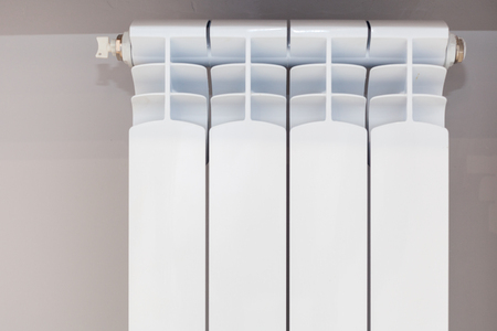 Heating white radiator with adjuster of warming in living room.の写真素材
