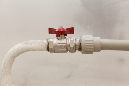 Heating white radiator with adjuster of warming in living room. Regulating valve for supplying heat  closeup.の写真素材
