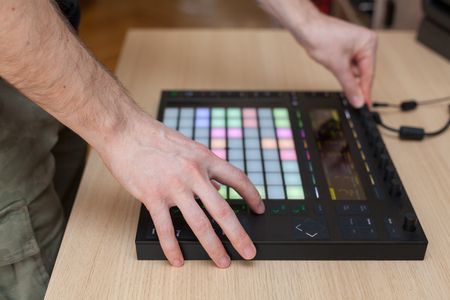 Producer makes a music on professional production controller with push button padsの写真素材