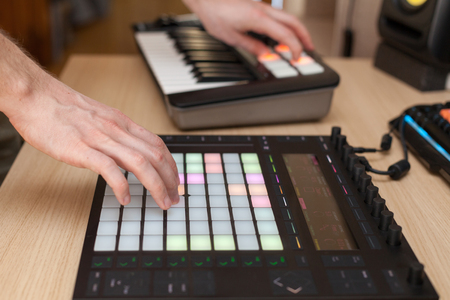 Producer makes a music on professional production controller with push button padsの写真素材