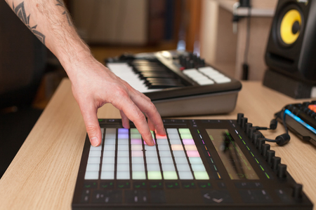 Producer makes a music on professional production controller with push button padsの写真素材