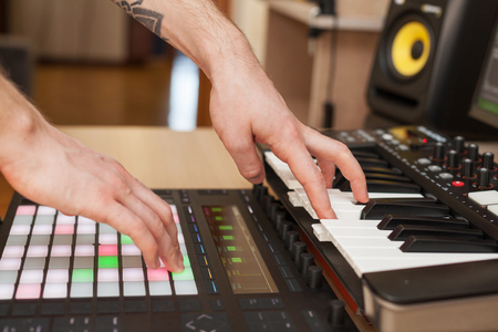 Producer makes a music on MIDI keyboardの写真素材