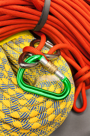 Red and yellow dynamic ropes and attached carabinerの写真素材