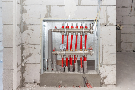 Domestic central heating installation, floor heating system, collector, battery. Heating concept and heating distributor. Underfloor heating with collector in the room.の写真素材