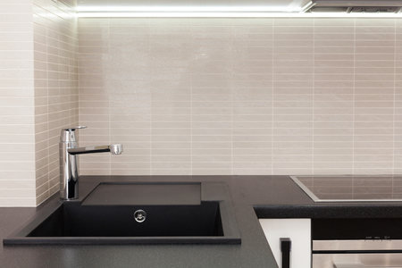New modern kitchen with built in oven and chrome water tapの写真素材