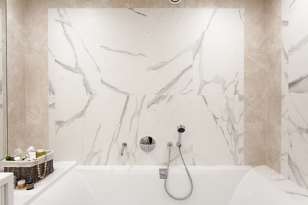 Bathroom interior. Bright bathroom with new tiles. Chrome shower, faucet, white bathroomの写真素材