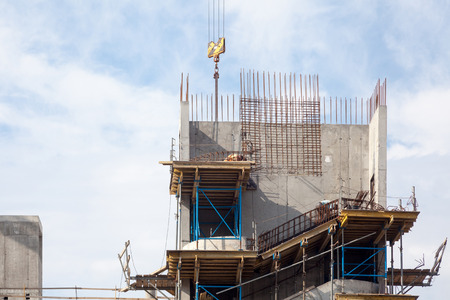 Crane and new mutlistoty building construction site. Construction of staircases.の写真素材