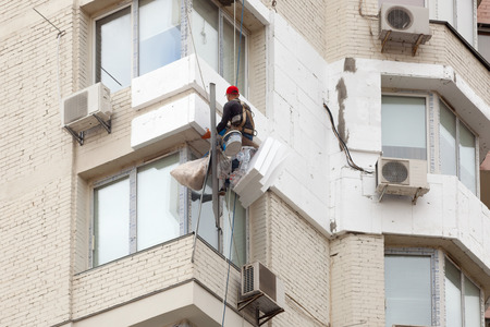 Wall Thermal insulation, industrial climbing, high-altitude work, insulation of walls with foam plastic or Styrofoamの写真素材