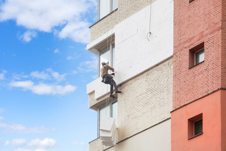 Wall Thermal insulation, industrial climbing, high-altitude work, insulation of walls with foam plastic or Styrofoamの写真素材