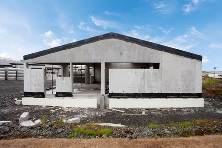 Construction of building of new white concrete house with incomplete wooden roofの写真素材