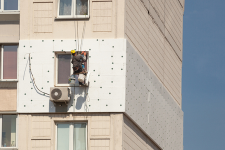 Wall Thermal insulation, industrial climbing, high-altitude work, insulation of walls with foam plastic or Styrofoamの写真素材