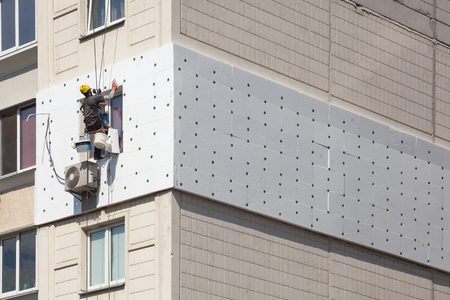 Wall Thermal insulation, industrial climbing, high-altitude work, insulation of walls with foam plastic or Styrofoamの写真素材