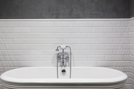 Bright bathroom with new tiles. Chrome shower, faucet, white bathroomの写真素材
