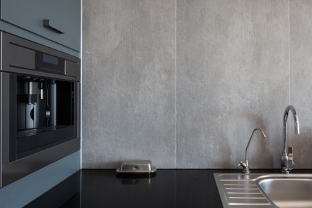New modern white kitchen with built in oven and chrome water tapの写真素材