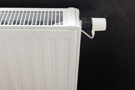 Heating white radiator with adjuster of warming in living room.の写真素材