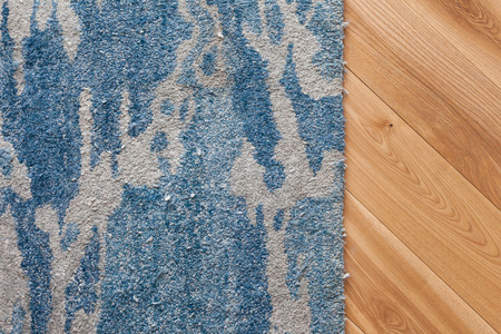 Decorative elements in the interior. A minimalistic carpet on a new parquetの写真素材