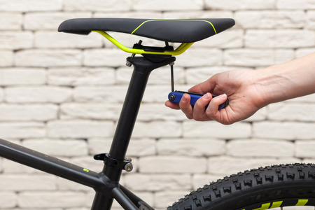 New modern road bicycle on white textured background. Element of a bicycle. A small bike repair.の写真素材