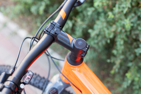 New modern road bicycle on a street background. Element of a bicycle steering wheel and helmの写真素材