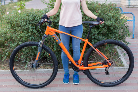 Young woman posing with bicycle on the street sport style picture. Girl with bicycle ready for tripの写真素材