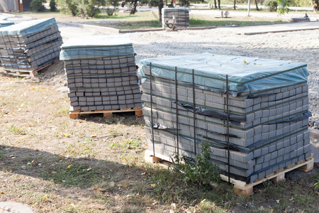 Sidewalk tiles stacked on a pallet. Gray figured paving slabs. Seamless tileable texture.の写真素材