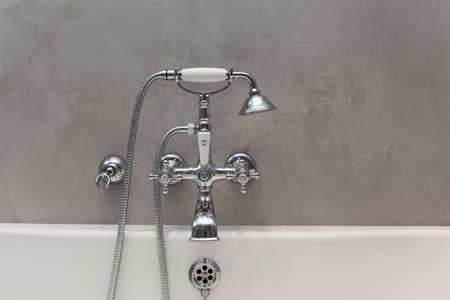 Bright bathroom with new textured wall and plumbing.の写真素材