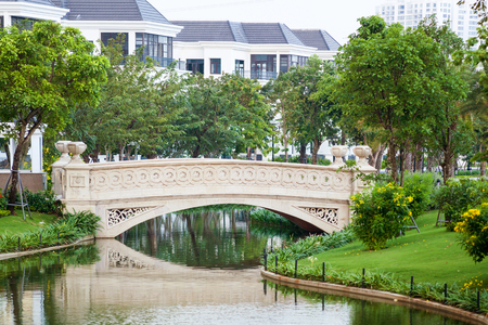 Beautiful tiny concrete bridge over the small riverの写真素材