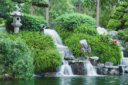 Japanese style mini waterfall with green plants. Landscape designの写真素材