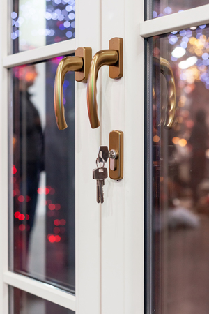 Plastic white door with lock and keyの写真素材