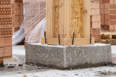 Beginning of the construction residential building. Close up photo of house support element on cement strong and lasting solid foundationの写真素材