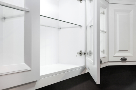 Close up cropped photo of open door in kitchen cabinet. Upscale interior conceptの写真素材