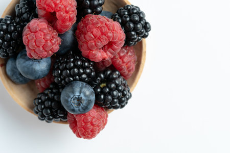 Top view and close up of mix different delicious, ripe and sweet blueberries, blackberries,...