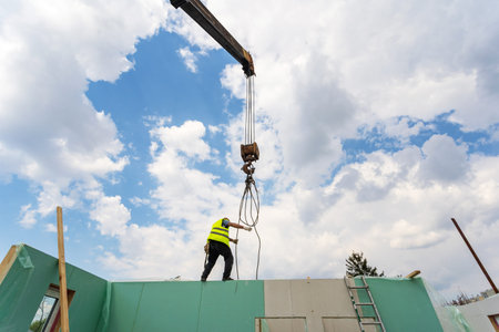 Process of construction new and modern modular house. Builder man in special protective uniform wear...