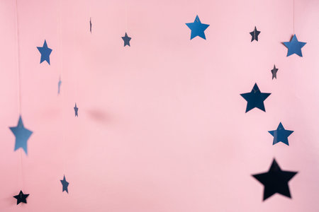 Small stars decor isolated against pink pastel and vivid background with copy or empty space for...
