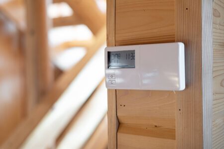 Digital device screen with smart home system on wall in modern living room against blurred background and copy spaceの写真素材