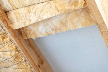 Copy space of new house under construction with rockwool insulation material on ceiling and copy space on wallの写真素材