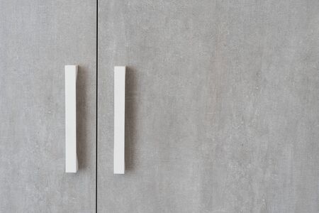 Close up of closed doors on wardrobe or cabinet and copy space at furniture facade. Element of modern interior design at homeの写真素材