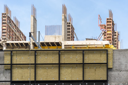 Concept of housing development project. Selective focus on building under construction with rock...