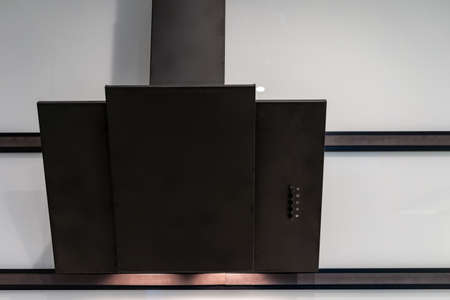 Element of new modern kitchen room with black contemporary cooking hood on copy space wall. Modern interior design with built in applianceの写真素材
