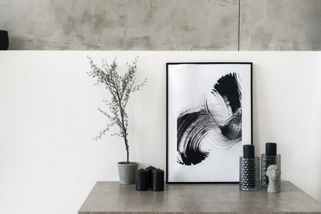 Table with home decor in living room. Modern interior house with abstract painting in frame,...